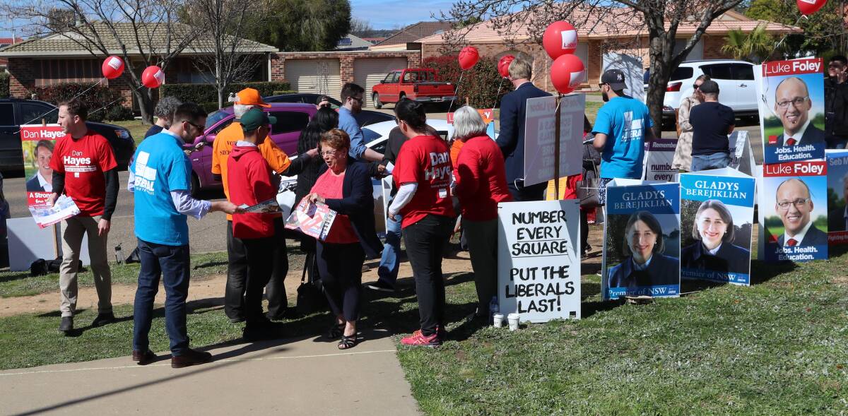 BATTLEGROUND: Voters run the gauntlet of political party volunteers during Wagga's byelection. Wagga's new political competitiveness could benefit the city