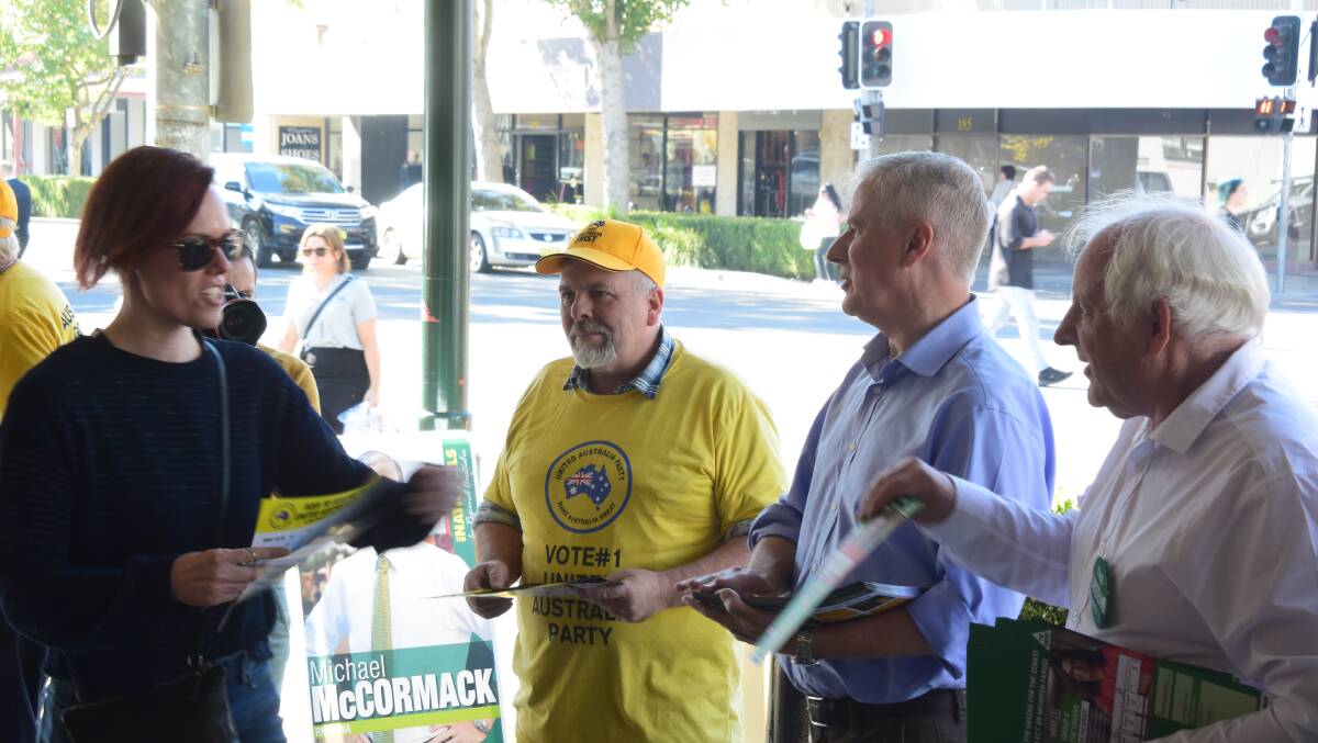Riverina Greens candidate Michael Bayles (right) Riverina Nationals MP Michael McCormack and United Australia Party candidate Richard Foley at Wagga's pre-poll centre on the last day of early voting in May. Picture: Rex Martinich