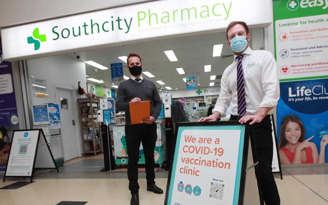 BOOKED OUT: Pharmacists and immunisers Luke Van der Rijt (L) and Thomas Adamson at Southcity Pharmacy, which has been getting inquiries from people looking for an early second jab. Picture: Les Smith