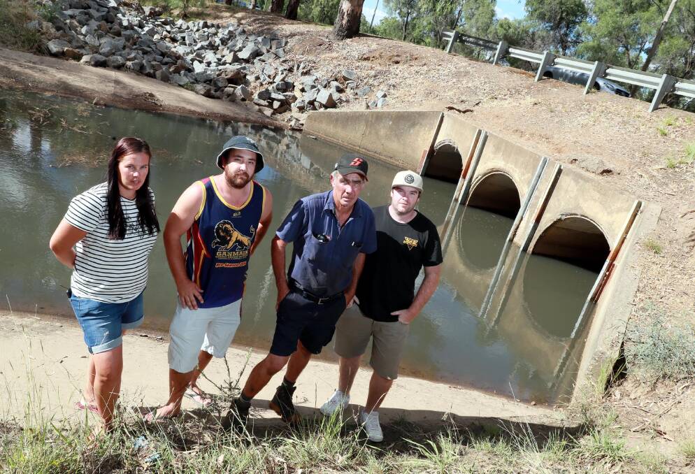 PROTEST: Wagga Boat Club commodore Mick Henderson (second from right) receives support from Jacinta Evans, Alex Crawford and Chris Ingram for his decision to take part in blocking off Tatton Drain to protest low water levels in Lake Albert.