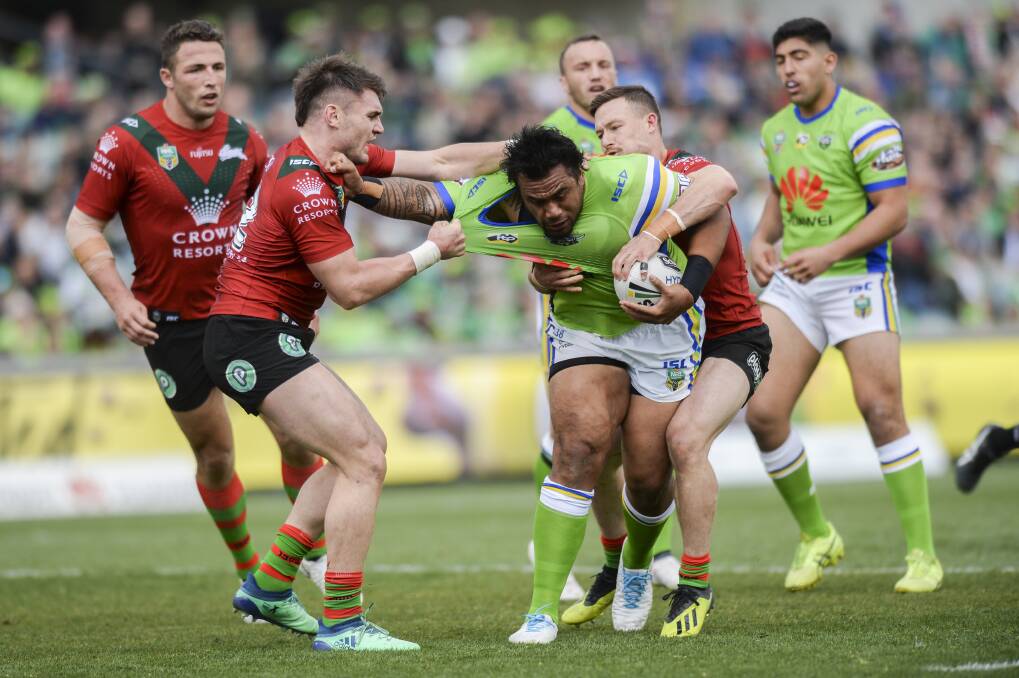 Junior Paulo of the Raiders is tackled by Angus Crichton and Damien Cook of the Rabbitohs during the Round 24 NRL match between the Canberra Raiders and the South Sydney Rabbitohs in Canberra on Saturday. Picture: AAP Image/Rohan Thomson.