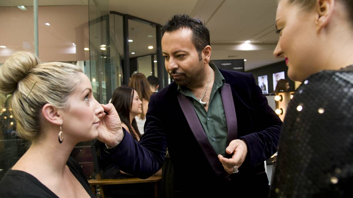 BETTER DAYS: Napoleon Perdis, founder of the makeup store chain that bears his name,touches up make-up during a masterclass in 2014. The national chain has now closed about half its stores, including at Wagga Marketplace.