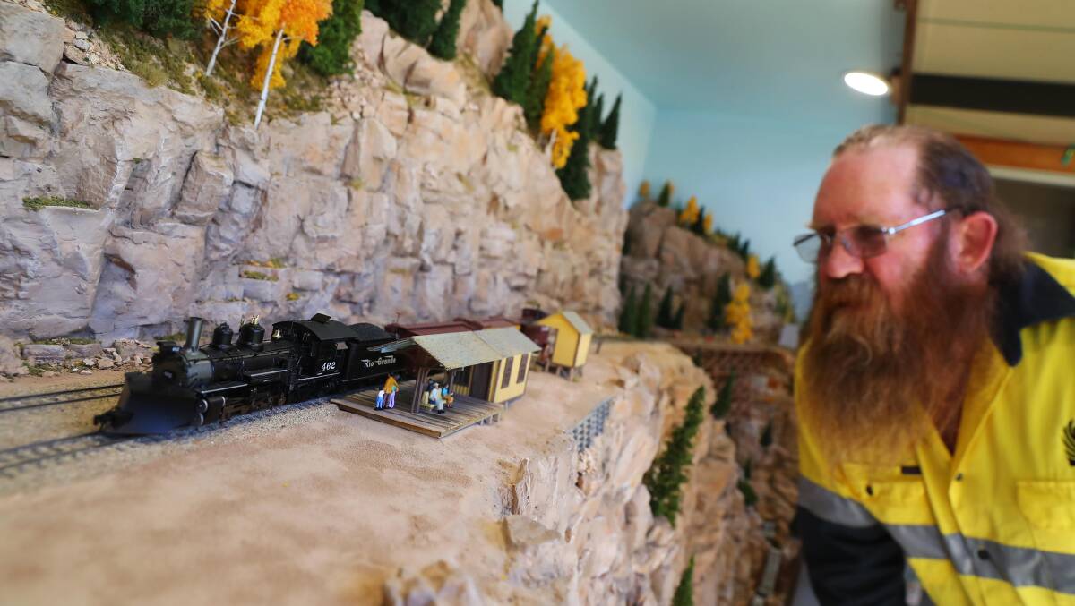 ADMIRING: Exhibition manager Dave Edgar takes a close inspection of Garry Edgar's layout, called 'Bobcat County'. Picture: Emma Hillier