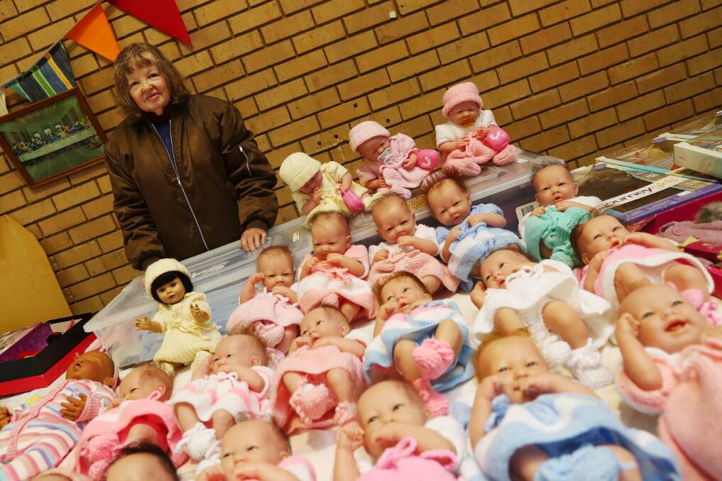 LABOURS OF LOVE: Stallholder Sandra Forrest with her reborn baby dolls. It takes about 60 hours to complete each one. Picture: Emma Hillier
