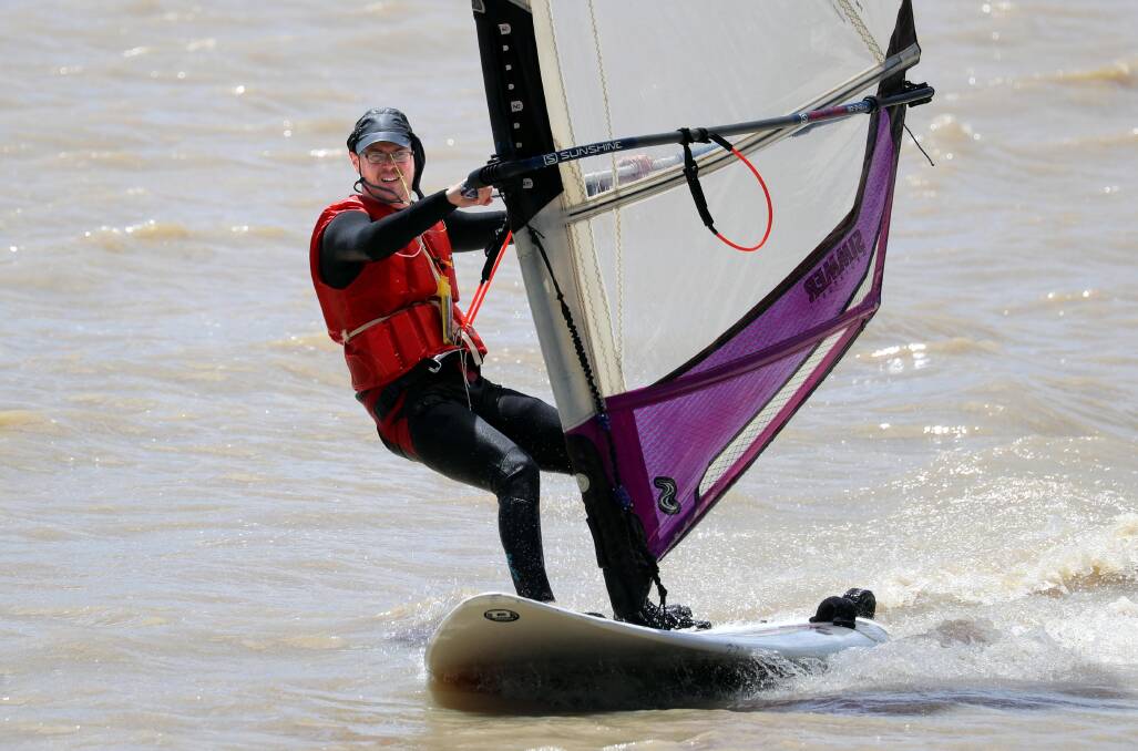 KEEPING COOL: The blustery and windy conditions on the second day of summer were ideal for Wagga lad Leonard Wilson, who took his windsurfer to Lake Albert for a few laps around the pond. Picture: Les Smith