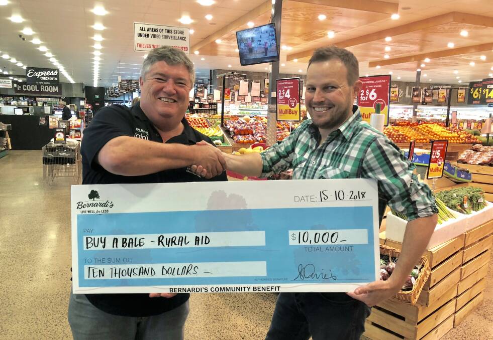 HELPING HAND: Charles Alder, Rural Aid Australia chief executive, receives $10,000 from Bernardi's co-CEO Joe Bernardi. Picture: Supplied