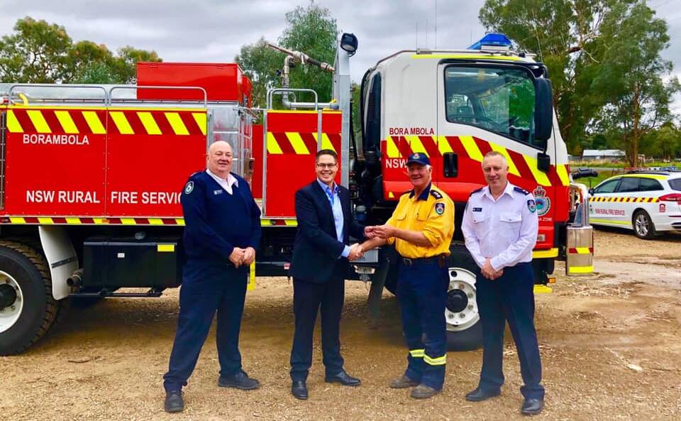 ENHANCED: Chief superintendent Ken Hall, Wes Fang MP, group captain Alan Brown and superintendent Roger Rorr accepts the delivery of a new truck at the Borambola brigade. Picture: Wes Fang