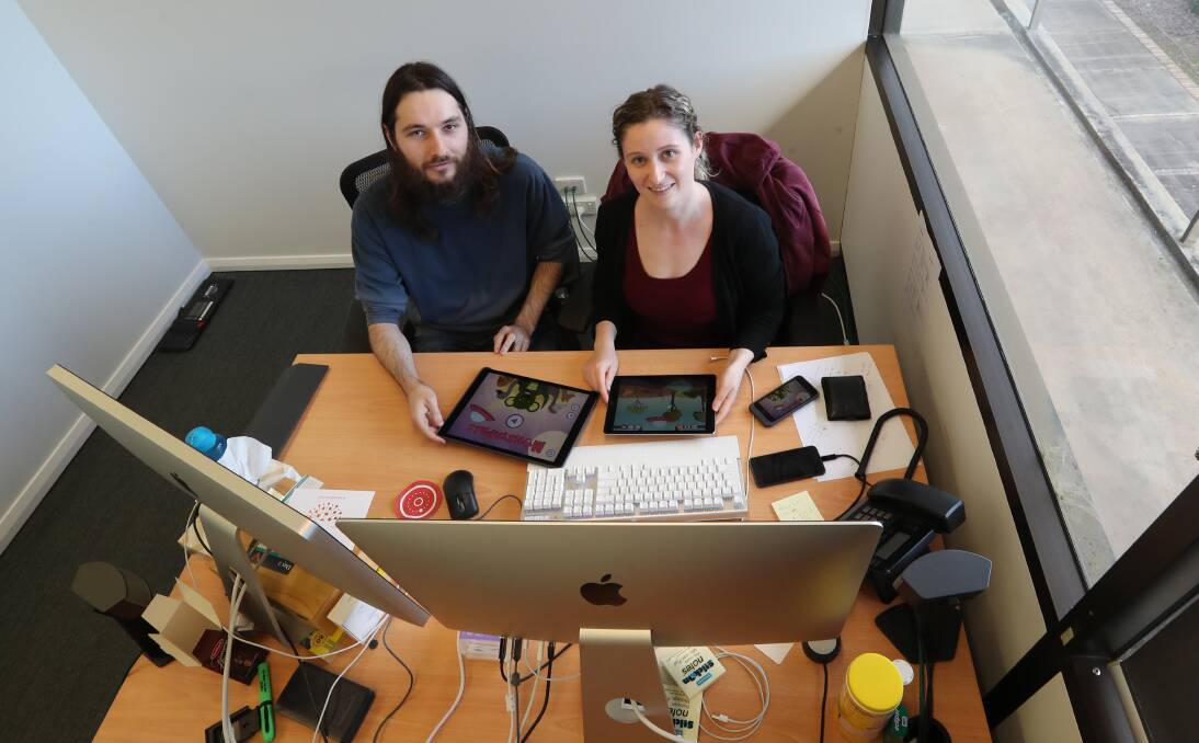 CREATORS: Game developer Bradley McLain with animator and illustrator Alice Peacock at the Anomaly office. Picture: Les Smith
