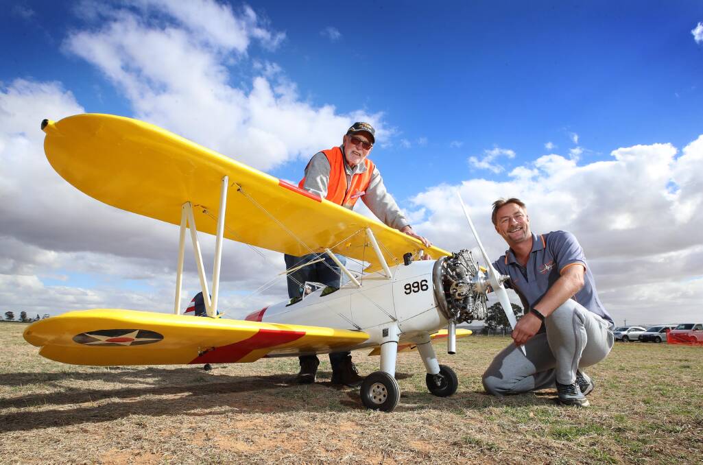 READY TO SOAR: Ian Waters with his scale model of a Boeing Stearman N2S and Wagga Model Aero Club president BJ Padman. Picture: Les Smith