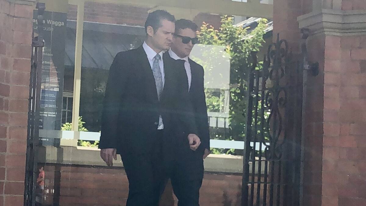 IN COURT: Rian Ross Toyer (right), 32, walks out of court with his defence solicitor (left).
