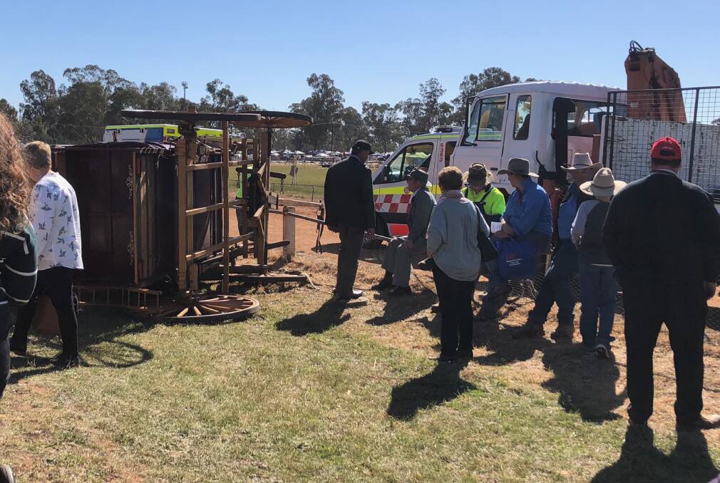 EMERGENCY: The stagecoach that flipped near a jumping castle at the Ganmain Show today. Picture: Nikki Reynolds