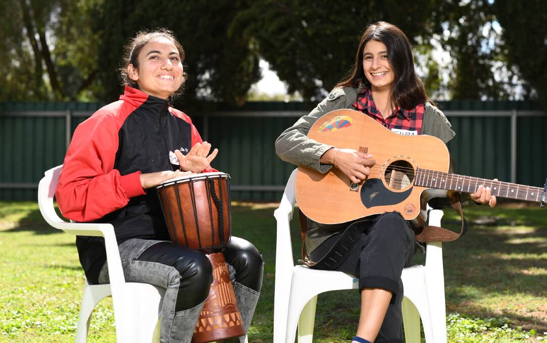 PASSION FOR MUSIC: Maryam Sulaiman, 17, and Tuba Gundor, 16, earlier in 2019 where they celebrated nine months of Wagga Multicultural Council's mentoring program.