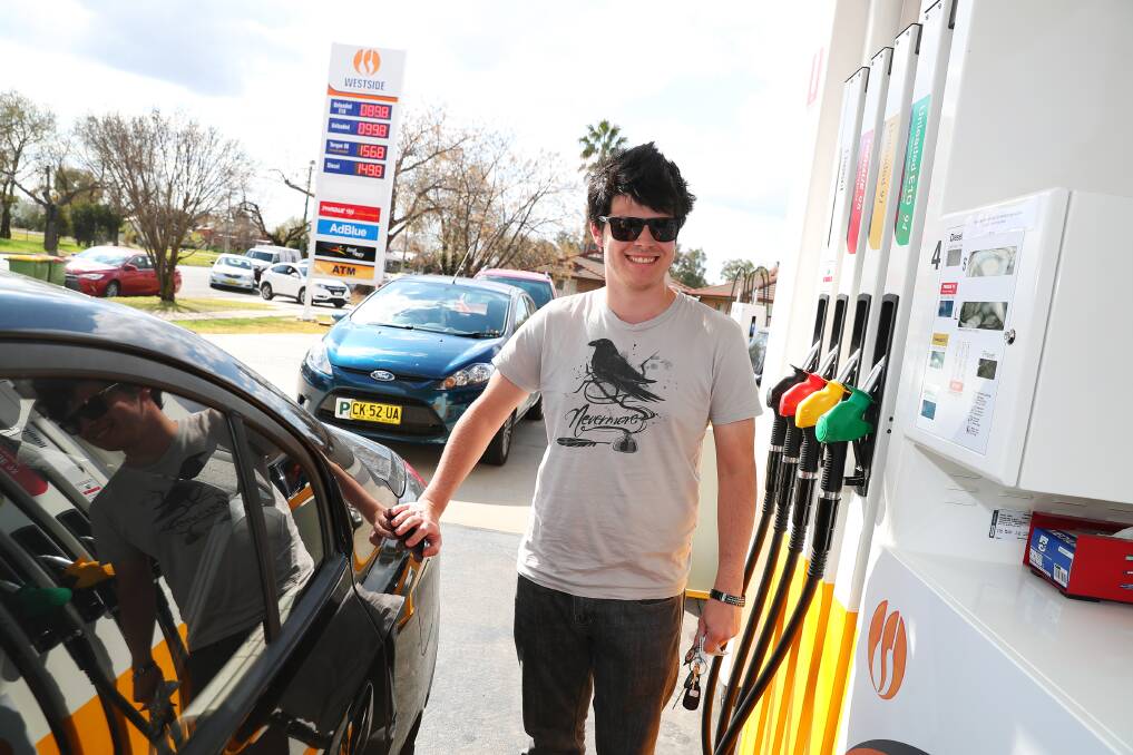 HAPPY: Jacob Honey fills his car while the low price remains. Picture: Emma Hillier