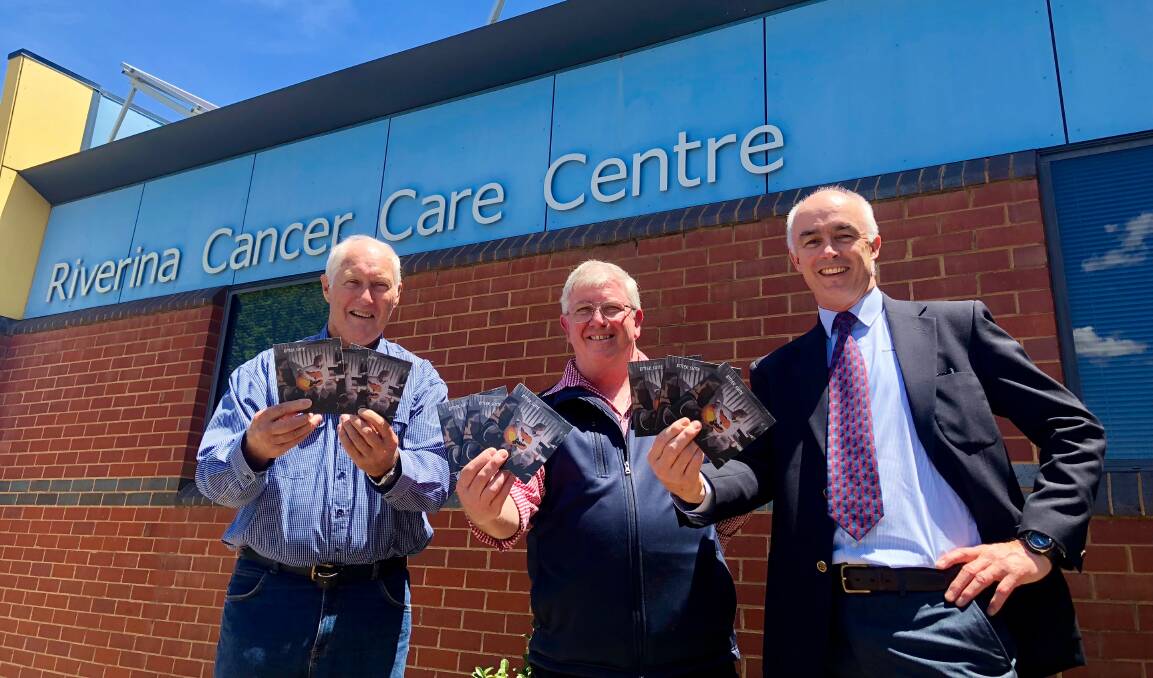LEGACY HONOURED: The Tin Shed Rattlers' Robert Whitaker and David Dunbar with Nick Menzies of the Riverina Cancer Care Centre with the final album by Noel Raynes. Picture: Toby Vue