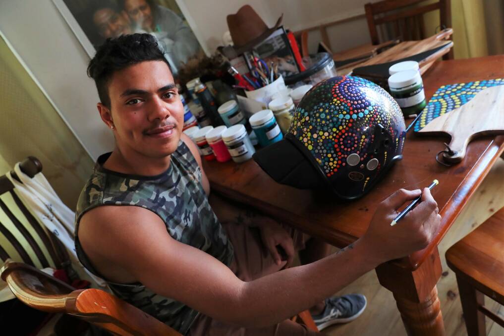PASSION ON SHOW: Artist Tyronne Hoerler with the police helmet at his studio.Picture: Emma Hillier