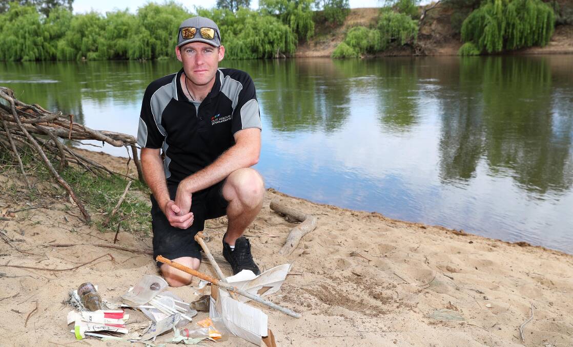 TAKING ACTION: Grant Higginson, a founding member of OzFish Wagga, with more rubbish found at Eunony Reserve only a couple of days after OzFish Wagga conducted a major cleanup on Sunday. Picture: Emma Hillier