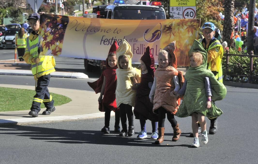 COLOURFUL: The Five Falling Leaves lead the street parade in Tumut.
