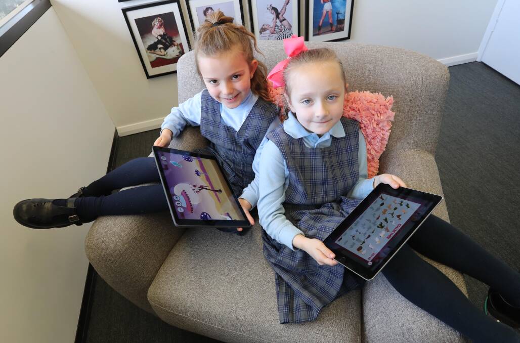 FUN AND GAMES: Six-year-olds Millie Hulme (left) and Sadie Salazar test drive 'Monstapals', which helps users learn more about native animals. Picture: Les Smith