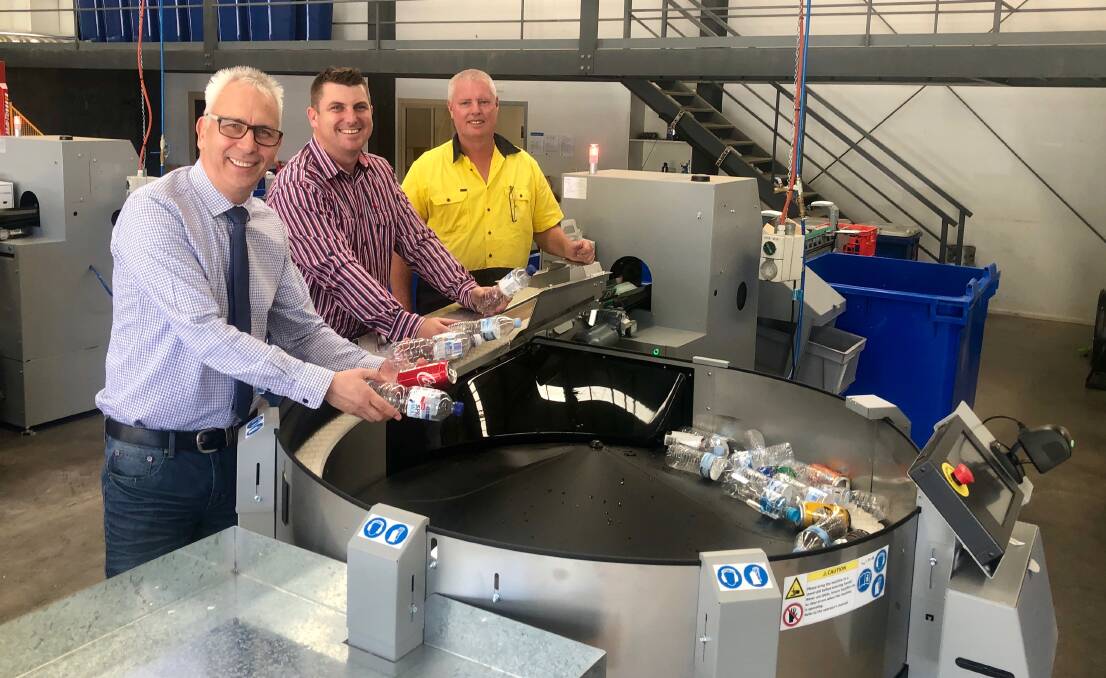 READY TO OPEN: St Vincent de Paul's executive officer Mike Riley, retail manager Mitchell Saddler and operation staff Trevor Knight recycling bottles and cans at the container deposit scheme at East Wagga. Picture: Toby Vue