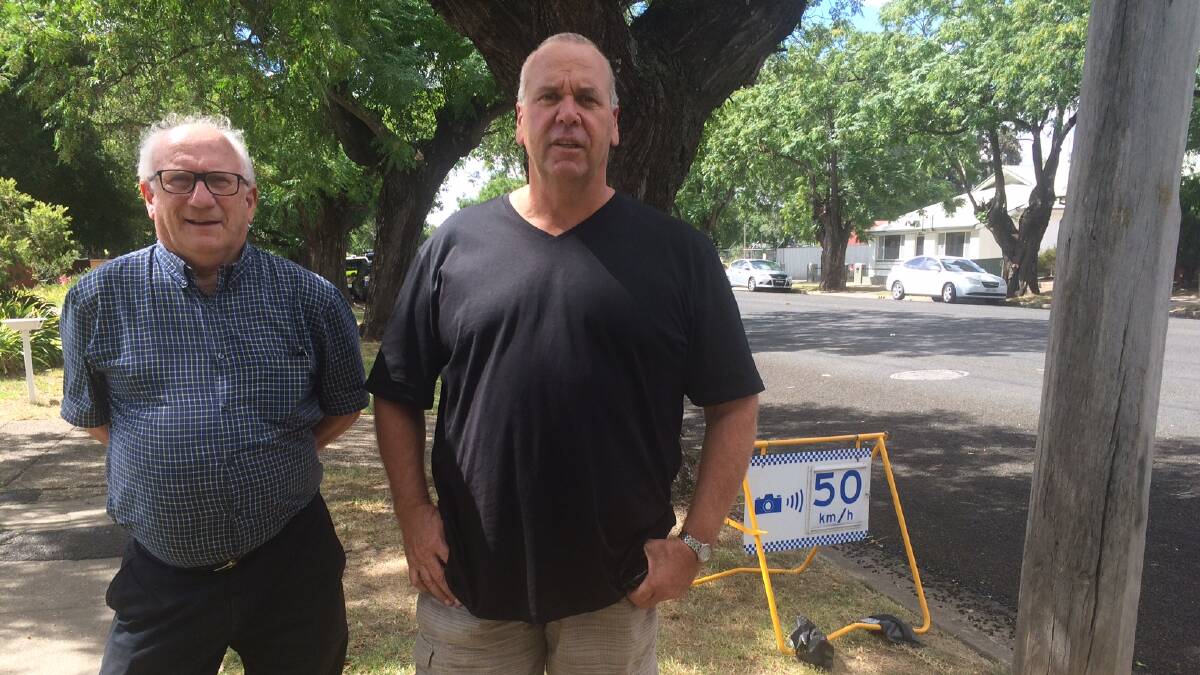 OUTRAGED: Australian Limousine Wagga driver Terry McMillan with councillor Paul Funnell pictured in front of one of the obscured signs. 