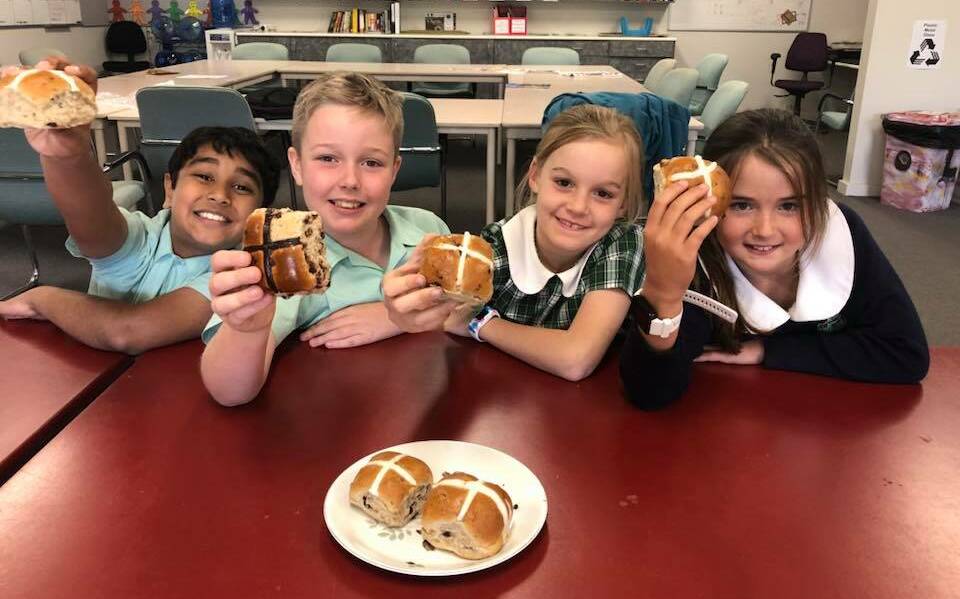 JUDGES: Lutheran Primary School students Jaiden Cherian, Will Pickering, Isabelle Armstrong and Stella Grintell, all age 9, try hot cross buns from four different businesses across Wagga.  