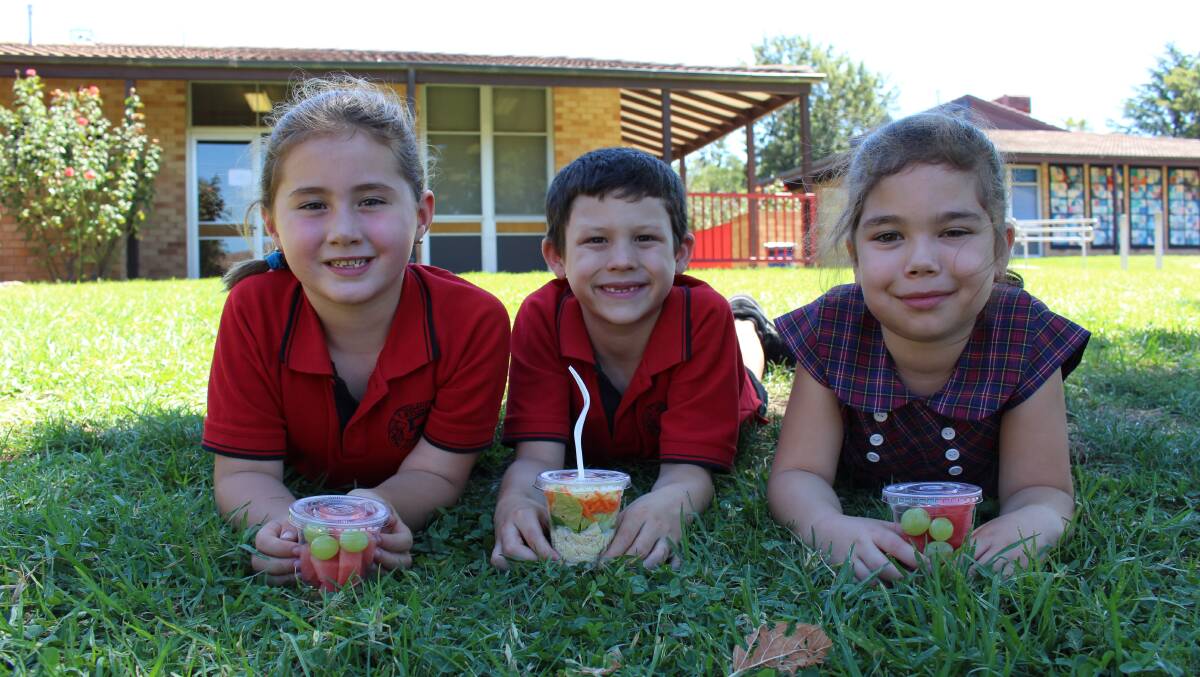HEALTHY EATING: Sturt Public School students Eliza Makeham, Year 1, Billy Davies, Year 2, and Iesha Walker, Year 2 enjoy healthy options at the school canteen. 