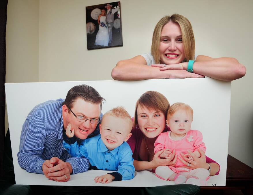 JOURNEY: Cystic fibrosis sufferer Jondie-Lee Wilks pict. at home with a portrait of her family. Picture: Kieren L Tilly 