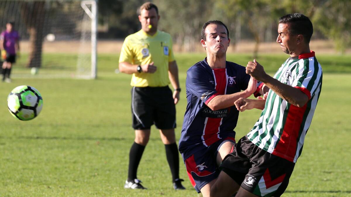 LONG BALL: Lake Albert captain Ben Angel clears the ball under pressure from Henwood Park's Isaac Tancredi. Lake Albert won the grand final rematch 4-1 at Rawlings Park. Picture: Les Smith