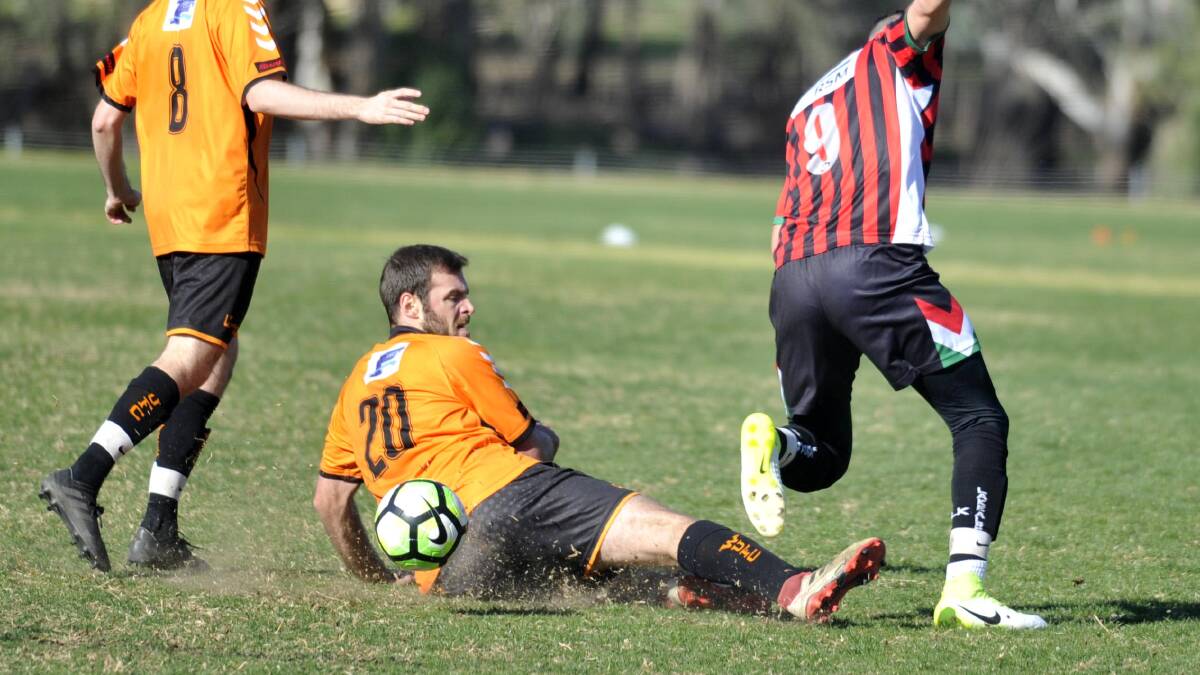 SLIDE: Richard Horvath gets underneath Henri Gardner during Wagga United's 1-all draw with Lake Albert on Sunday. Picture: Chelsea Sutton