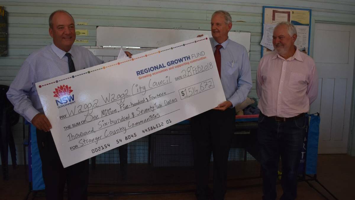 BIG BOOST: Member for Wagga Daryl Maguire hands over $1.5 million in funds for a number of projects across Wagga to mayor Greg Conkey and councillor Rod Kendall.