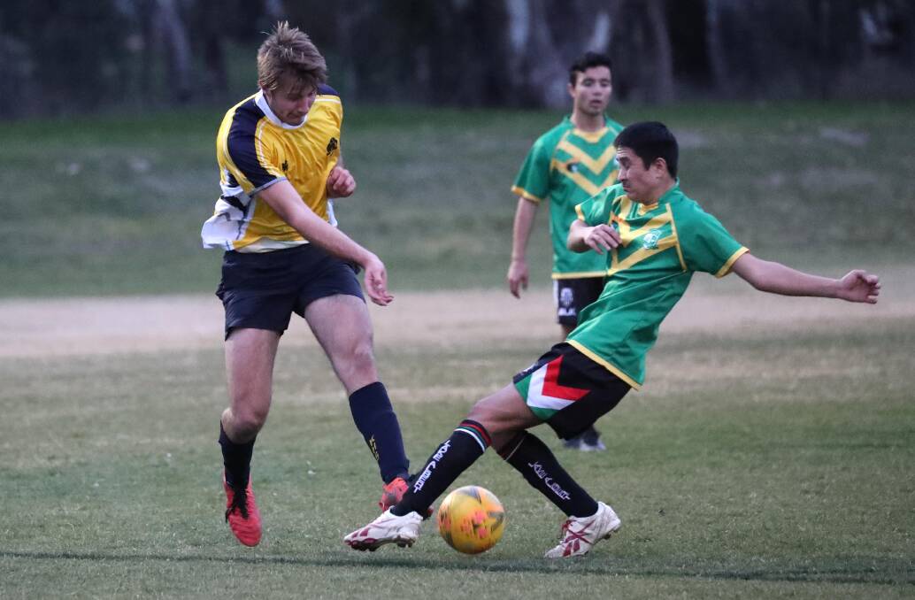 HAMMER AND TONGS: George Kendall (Kooringal) and Abdullah Bagheri (Mount Austin) contest for possession during their Creed Shield opener on Wednesday night. Picture: Les Smith