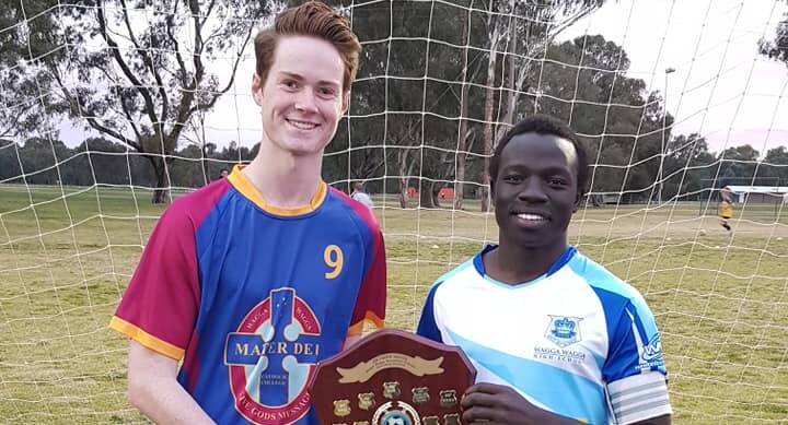SPOILS OF WAR: Mater Dei Catholic College's Jackson Holmes and Wagga High's Jacob Ochieng showcase the prize they'll be battling for on Wednesday night.