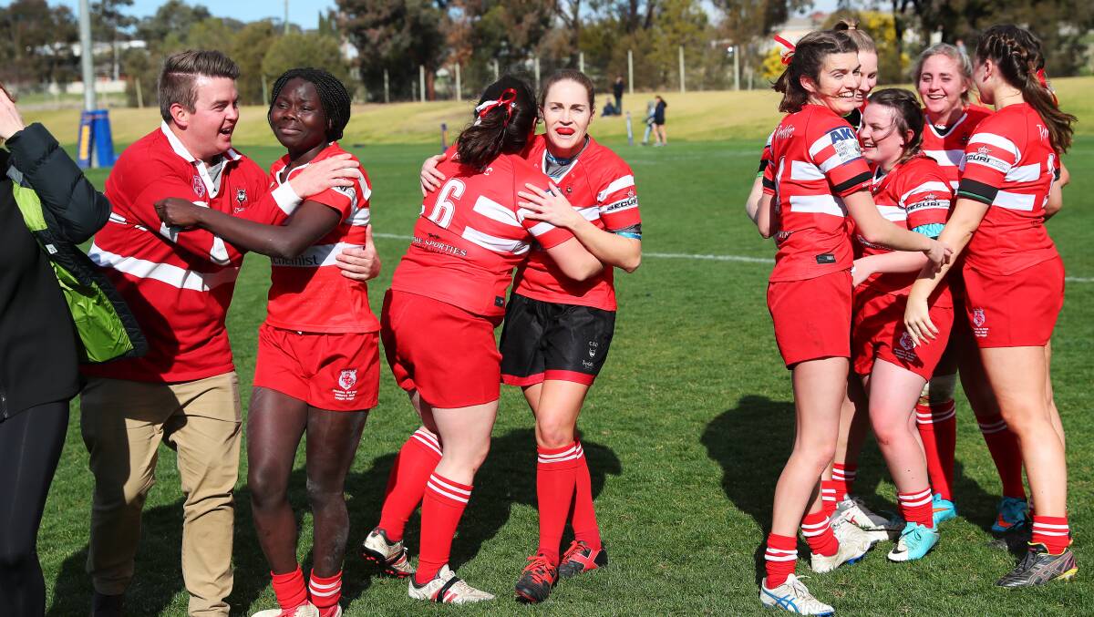 CELEBRATION TIME: CSU Reddies embrace after the whistle blows on their grand final win. Picture: Emma Hillier