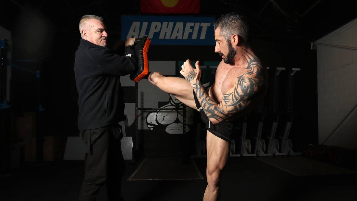 AIMING HIGH: Glen Kelk and Aaron Pearce demonstrate a kickboxing workout ahead of the launch of their new martial arts fitness classes. Picture: Les Smith