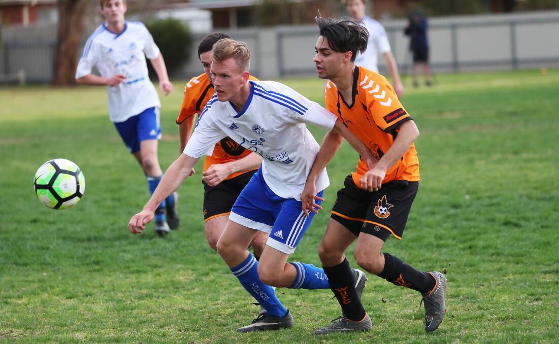 RACE TO THE BALL: Tolland's Aaron Harley and Wagga United's Liam Brown charge ahead during their elimination final clash. Picture: Emma Hillier