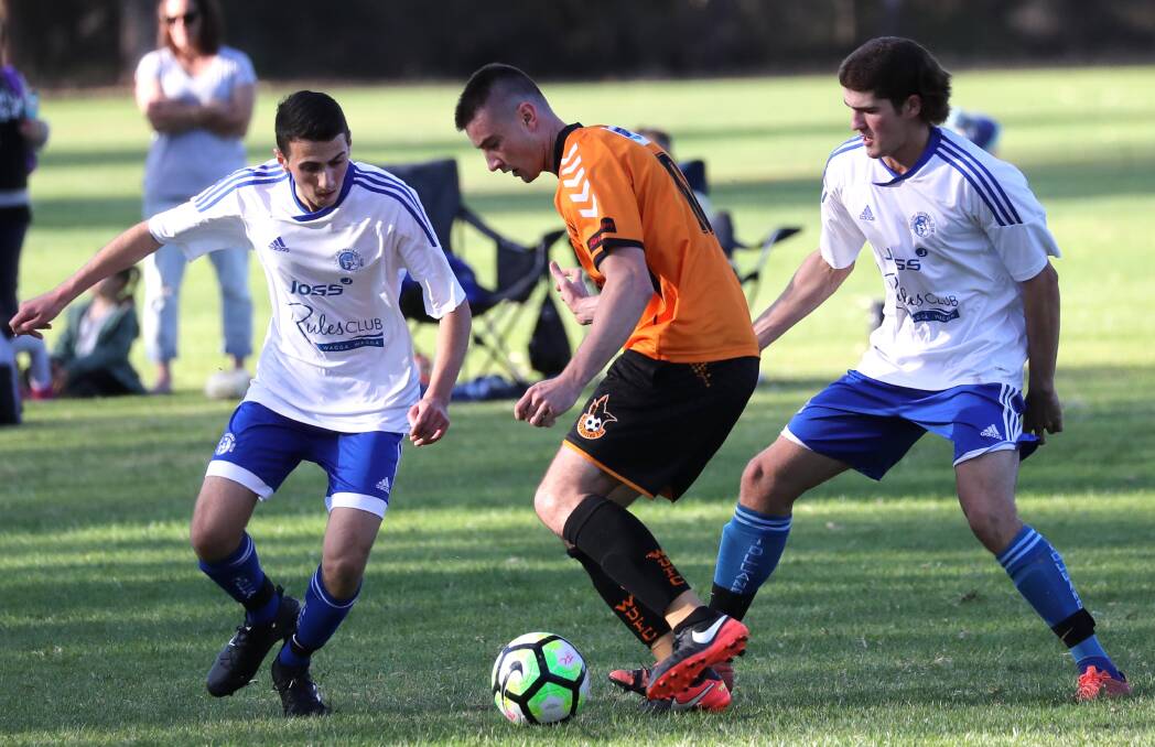 OPPOSITION: Wagga United's Jack Schein tries to evade Tolland's Jaiden O'Brien and Domenic Ciampa during Sunday's clash at Rawlings Park. Picture: Les Smith. 