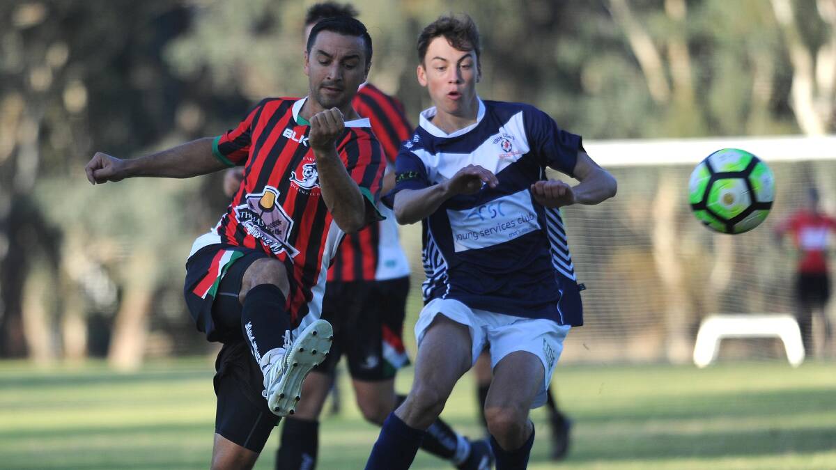 MARK UP: Lake Albert skipper Ben Angel clears past Young's Isaac Hines during 2017 Pascoe Cup game. 