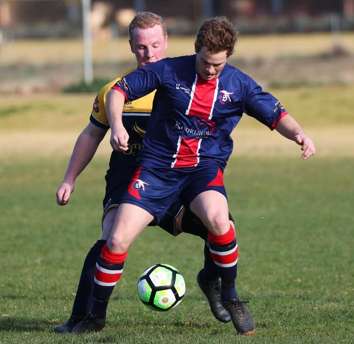 LOOK BEHIND YOU: Joel Tancredi of Henwood Park tries to control the ball under pressure from Junee's Ben Cook during their Pascoe Cup clash at Burns Park on Sunday. Picture: Emma Hillier