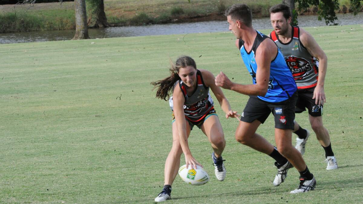 NEW CHALLENGE: Dragons flyer Ellen McIntyre slams the ball down for team mate Kassidy Argus while Sharks captain Andrew Baggio retreats.