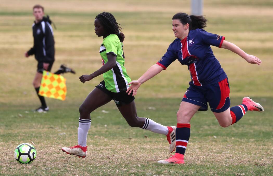 RACE TO THE BALL: Biola Dawa and Claudia Fallon contest for possession during Henwood Park's 5-1 win over South Wagga. Picture: Les Smith