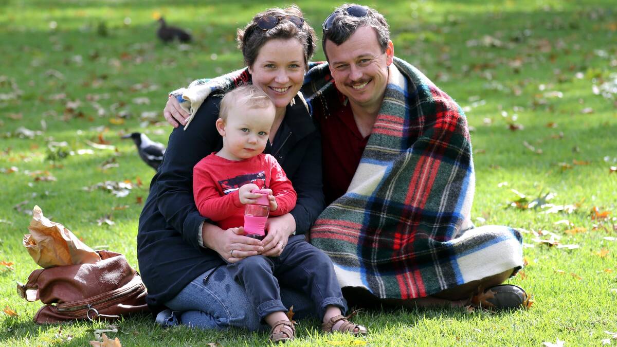 RUGGED UP: Bernard and Veronica Townley-Jones with their two-year-old son, Bernard, enjoy a chilly afternoon in the gardens. Picture: Les Smith