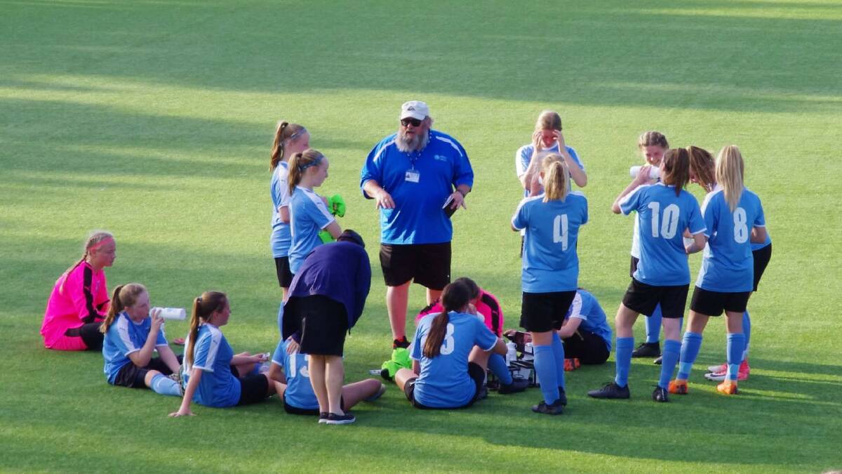 REAL TALK: Coach Rod Buik (centre) leads team discussions during a half time chat at the Football NSW State Titles. Picture: Contributed