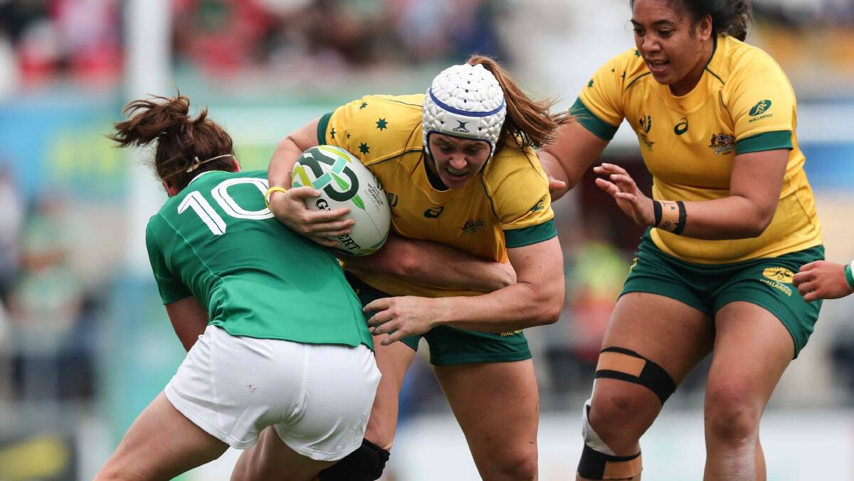 HARD TO STOP: Batlow's Sharni Williams (centre) in action for Australia against Ireland at the Women's Rugby World Cup last year. Picture: World Rugby