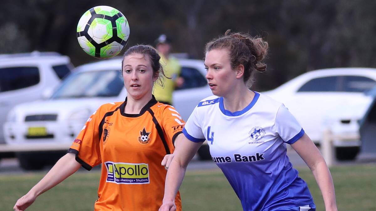 HEADS UP: Wagga United's Molly Antone and Tolland's Rachael Long set their sights on the ball during the final round of regular season Leonard Cup soccer. Picture: Les Smith