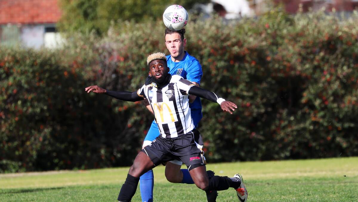 HEAD TO HEAD: Damion Patterson tried to break free and regather possession against Hurstville FC during Saturday's clash at Gissing Oval. Picture: Emma Hillier