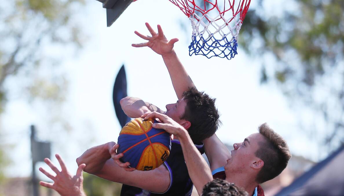 PHYSICAL AFFAIR: Fireballs' Shanon Klein gets double teamed by Llamas duo Jacob Edwards and Josh McPherson during the grand final of the Champions League Basketball 3X3 Wagga tournament. Picture: Emma Hiller