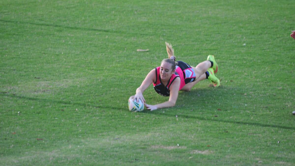 TRY TIME: Olivia Frazier dives over to complete her hat-trick.