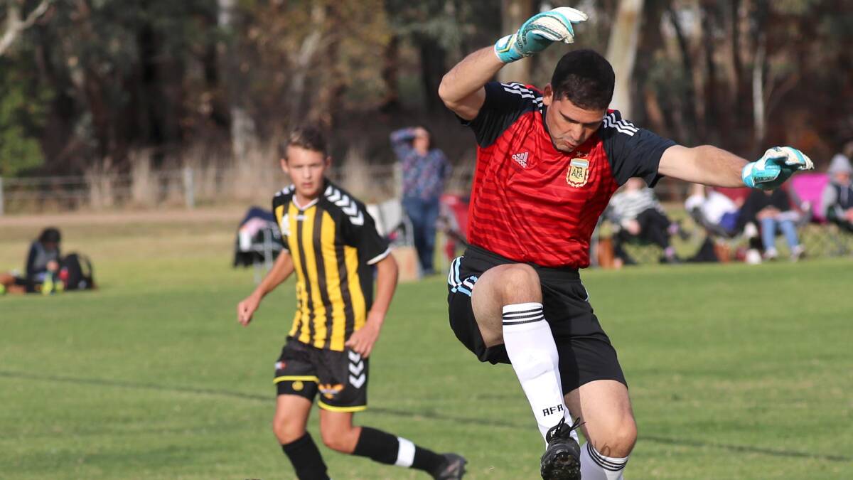 HANGTIME: Tumut keeper Martin Canteros takes to the sky during the Eagles' loss to Tolland