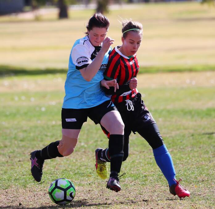 CONTEST: Janine Lambert and Kristen Prior fight for possession during Lake Albert's 1-all draw with Cootamundra in the Leonard Cup at Rawlings Park on Sunday. Picture: Emma Hillier