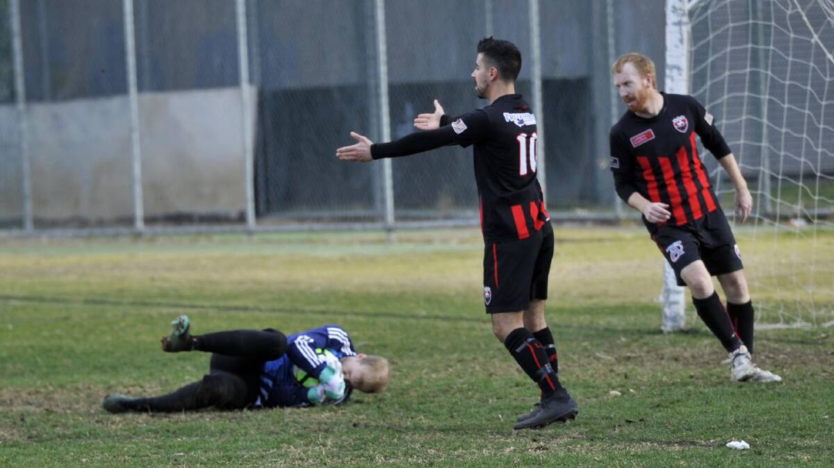 ON THE APPEAL: Leeton's Aidan Amato (centre) throws his hands out after goalkeeper Jarrod Sillis hits the deck hard during their 6-0 loss to Lake Albert last week. Picture: Chelsea Sutton 